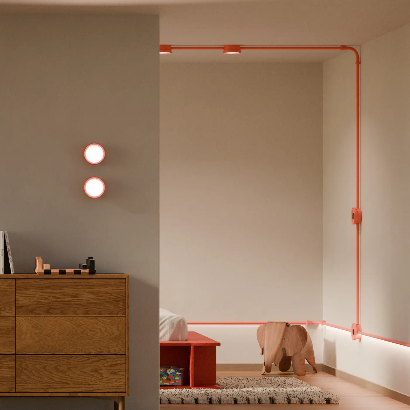 Kamer met oranje Genuit-buis en twee ronde wandlampen
